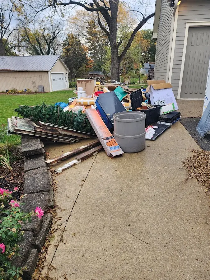 Dumpster being loaded with debris for Roofing Dumpster Rental in Clyde